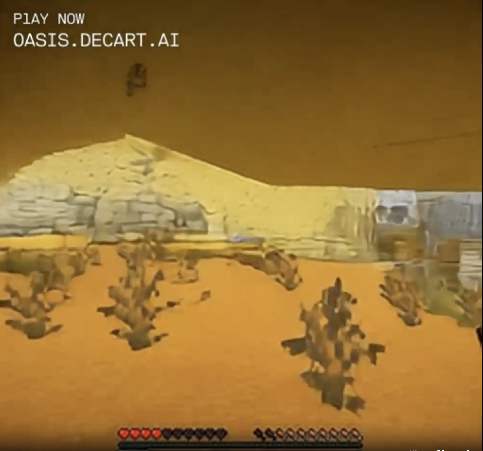 View from a sandy cave filled with brown sagebrush-looking desert plants. Through the long wide cave opening a desert landscape is visible, though it's not clear if these are hills of sand or sandstone or stone.